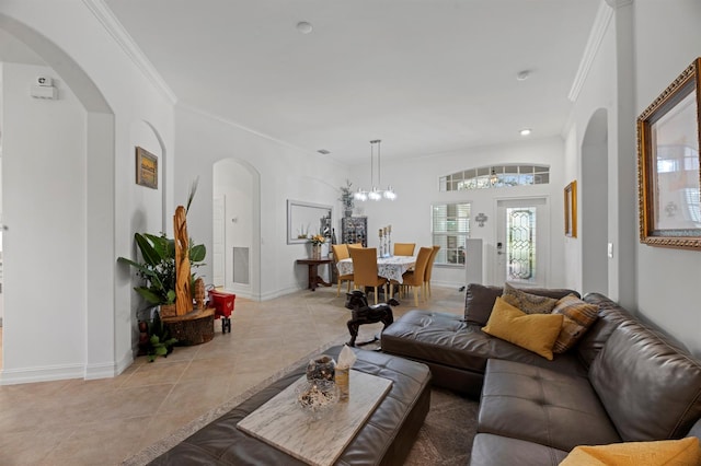 living room featuring crown molding, a notable chandelier, and light tile patterned floors