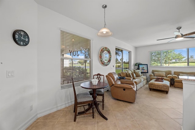 living room with ceiling fan, plenty of natural light, and light tile patterned floors