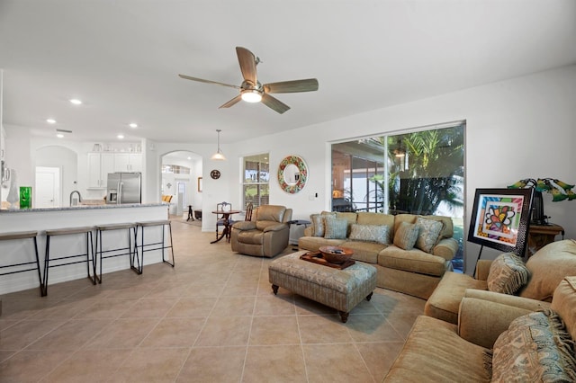 living room with light tile patterned floors and ceiling fan