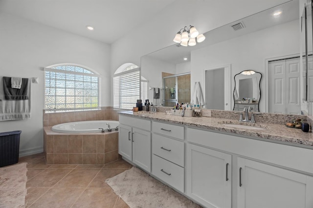 bathroom with vanity, shower with separate bathtub, and tile patterned flooring