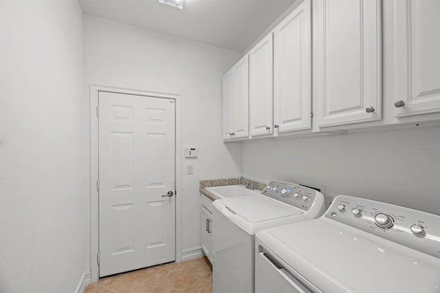 laundry room with sink, light tile patterned flooring, independent washer and dryer, and cabinets