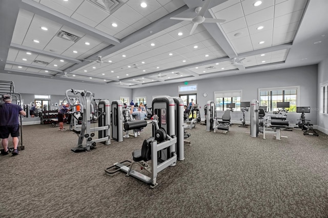 workout area featuring a towering ceiling, carpet flooring, and ceiling fan