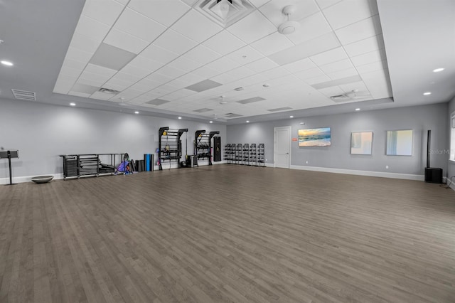 exercise area with a drop ceiling and hardwood / wood-style flooring