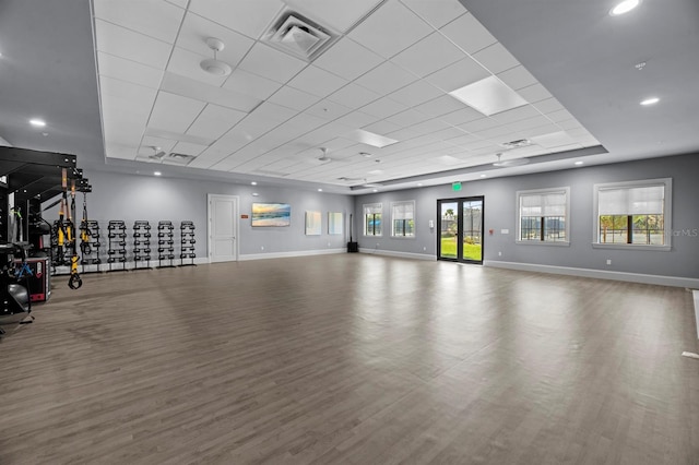 gym featuring a drop ceiling and hardwood / wood-style floors