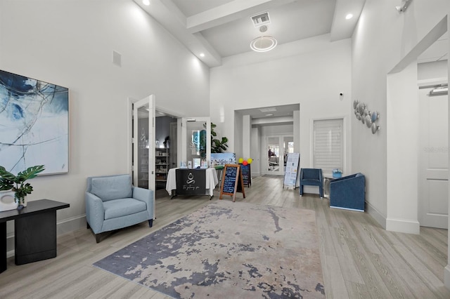 entrance foyer with a towering ceiling and light hardwood / wood-style floors