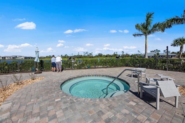 view of pool featuring a hot tub and a patio