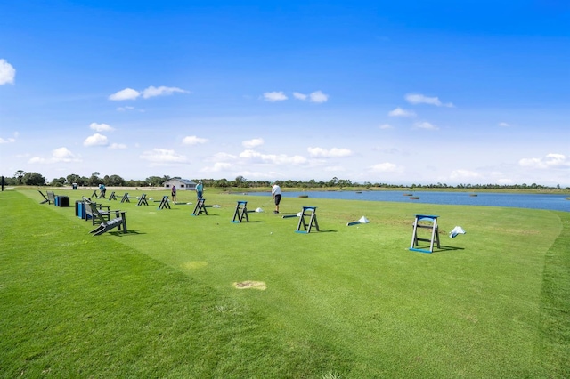 view of property's community featuring a lawn and a water view