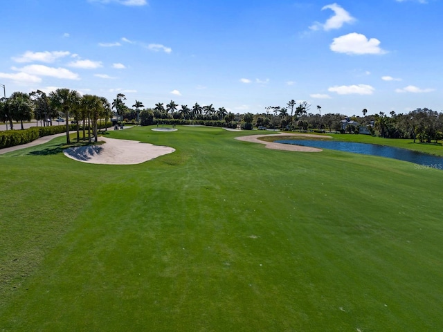 view of community featuring a water view and a lawn