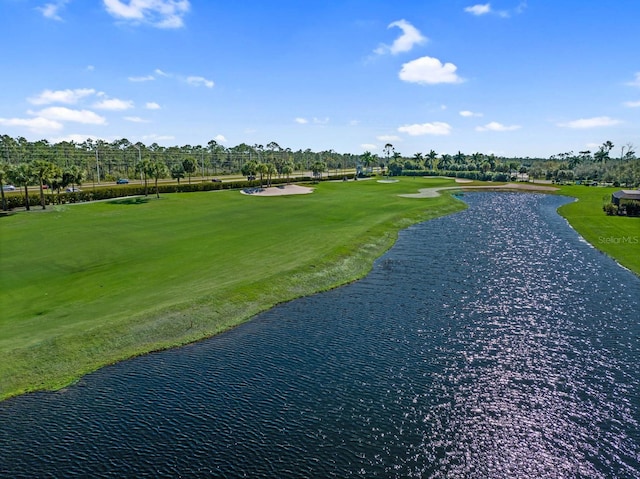 view of property's community featuring a yard and a water view