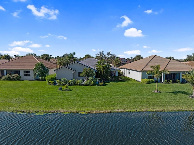 view of front of home featuring a front yard and a water view