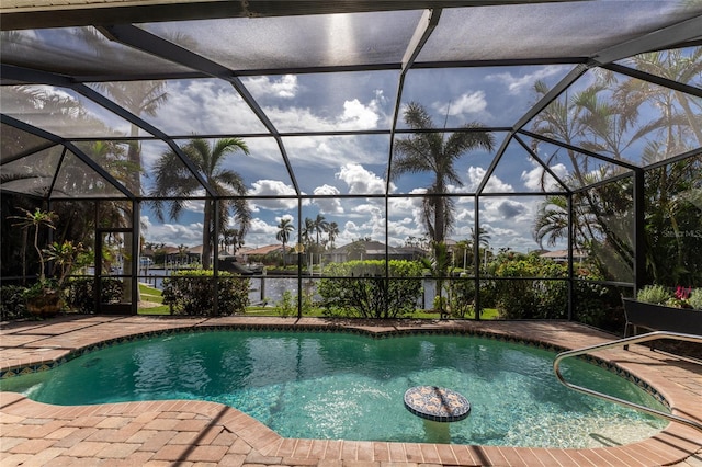 view of swimming pool featuring glass enclosure and a patio area