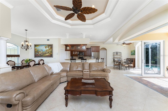 living room with ceiling fan with notable chandelier, a raised ceiling, and crown molding