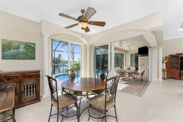 tiled dining area with ceiling fan, ornate columns, and crown molding