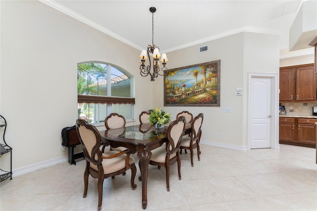 dining area featuring a chandelier, light tile patterned floors, and crown molding