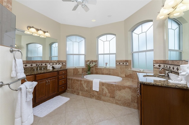 bathroom featuring vanity, tiled bath, ceiling fan, and tile patterned floors