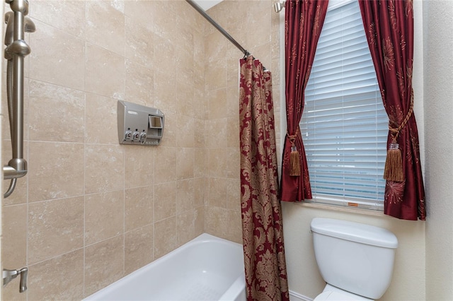 bathroom with shower / tub combo with curtain, toilet, and a healthy amount of sunlight