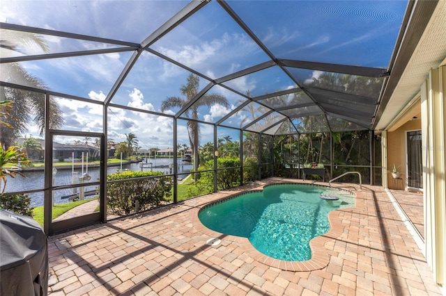 view of pool featuring a water view, glass enclosure, and a patio