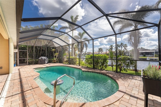 view of swimming pool featuring a lanai, a patio, and a water view