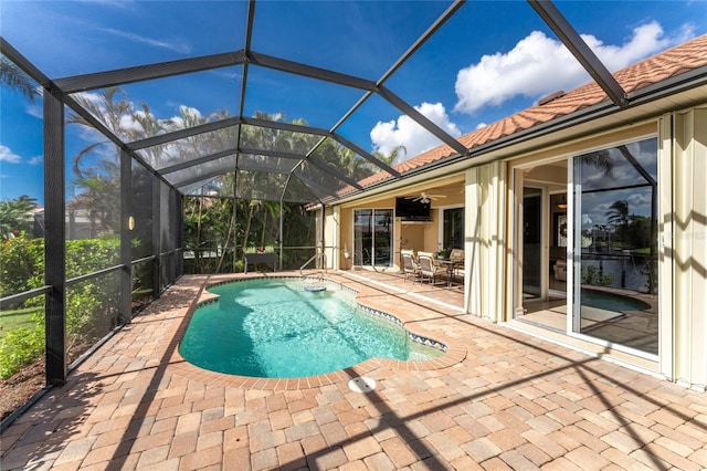 view of pool featuring ceiling fan, a lanai, and a patio area