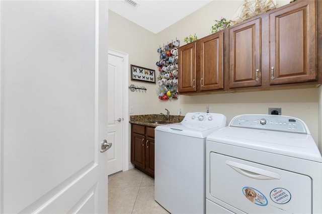 laundry room featuring cabinets, washing machine and dryer, light tile patterned floors, and sink