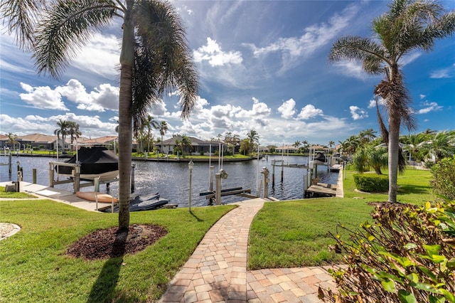 dock area with a yard and a water view