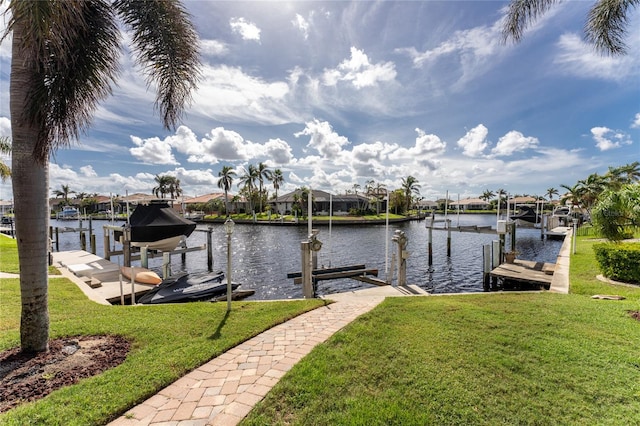 dock area featuring a lawn and a water view