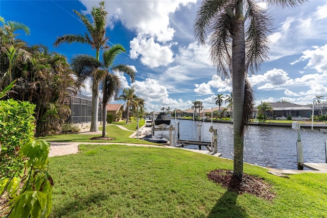 dock area with a yard and a water view