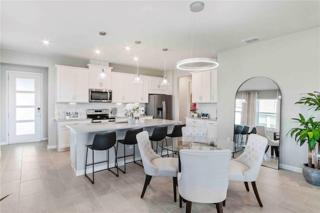 dining space featuring light tile patterned floors