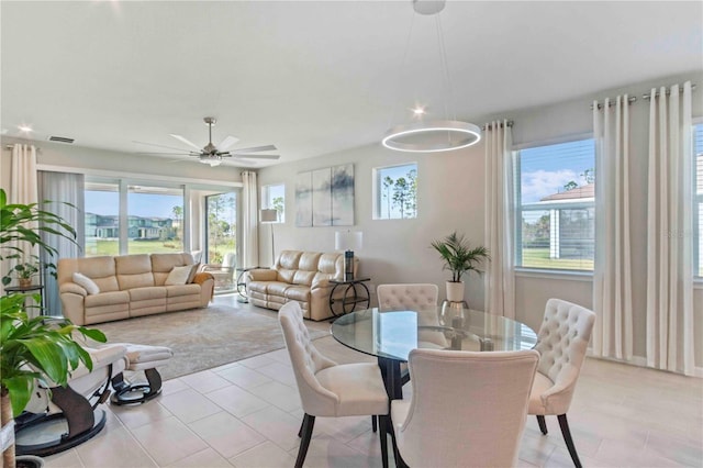 dining space featuring ceiling fan and light tile patterned floors