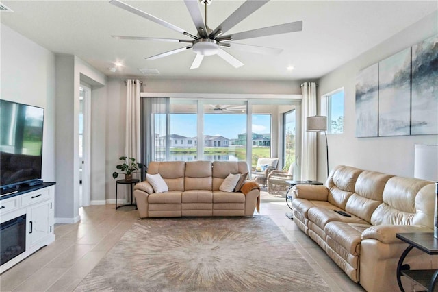 living room with a water view and ceiling fan