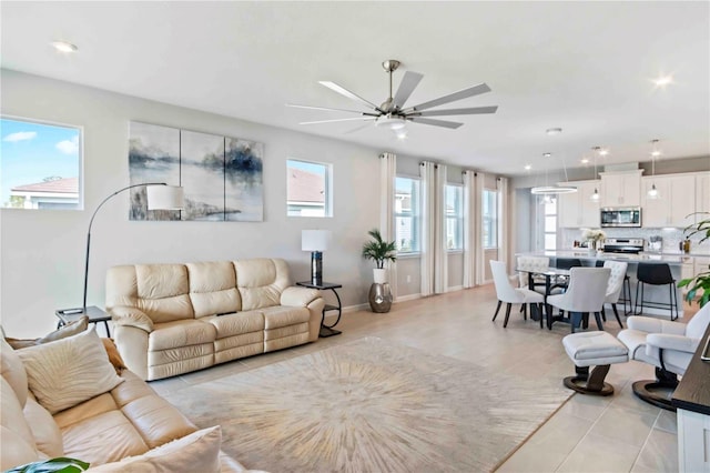 tiled living room featuring ceiling fan