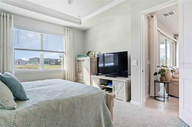 bedroom featuring light colored carpet, ceiling fan, and a tray ceiling