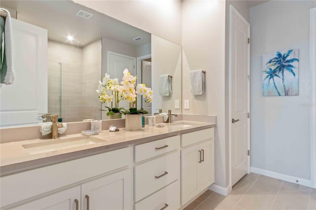 bathroom with vanity, a shower with shower door, and tile patterned flooring