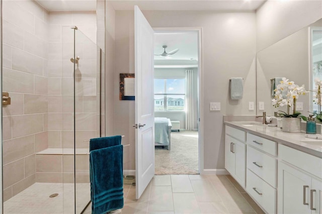 bathroom featuring vanity, a shower with shower door, and tile patterned flooring