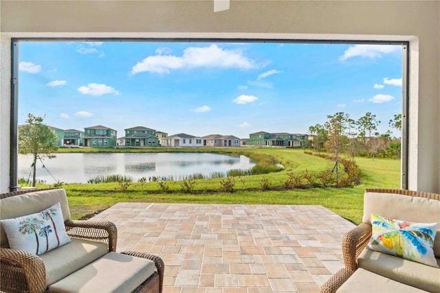 view of patio / terrace with a water view and an outdoor living space