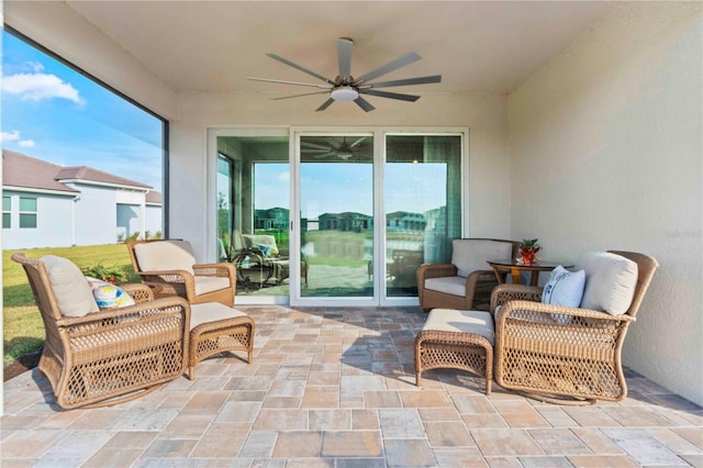 sunroom / solarium with plenty of natural light and ceiling fan