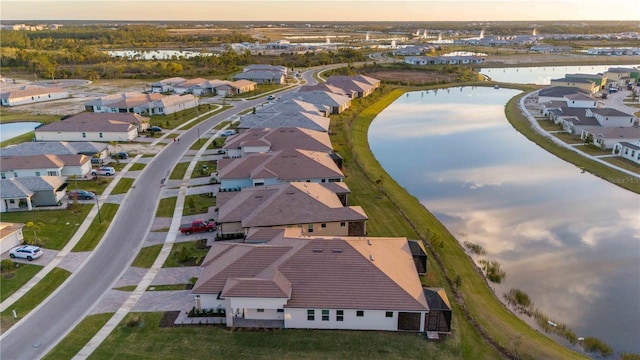 aerial view at dusk with a water view