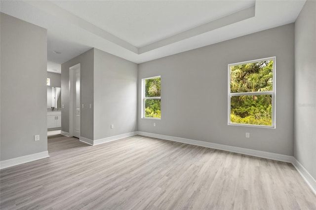 2404 Hanford Ln, North Port, FL 34288 - spare room featuring light wood-style floors, baseboards, and a wealth of natural light