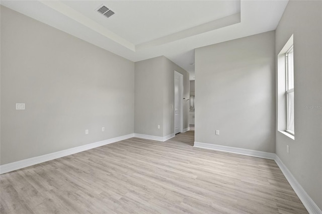 2404 Hanford Ln, North Port, FL 34288 - unfurnished room with visible vents, a raised ceiling, light wood finished floors, and baseboards