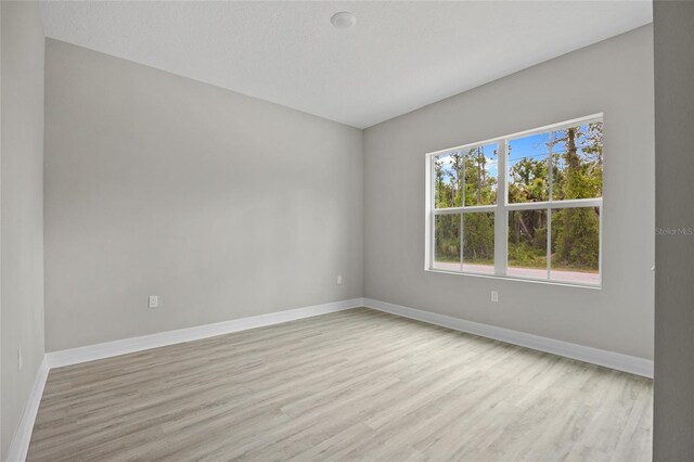 2404 Hanford Ln, North Port, FL 34288 - unfurnished room featuring baseboards and light wood-style flooring