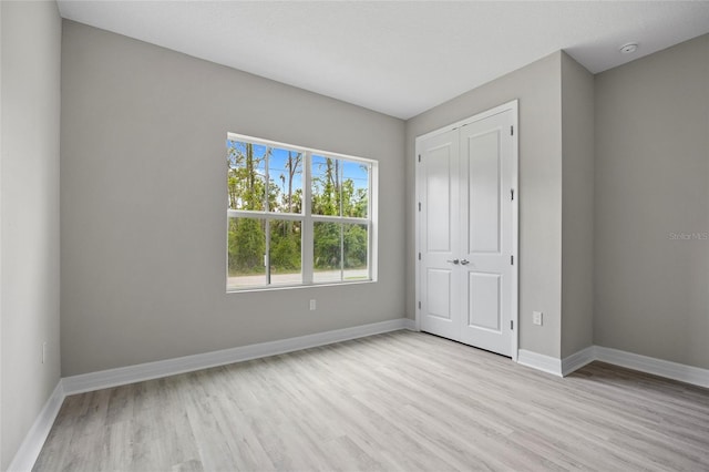 2404 Hanford Ln, North Port, FL 34288 - unfurnished bedroom with baseboards, wood finished floors, and a closet