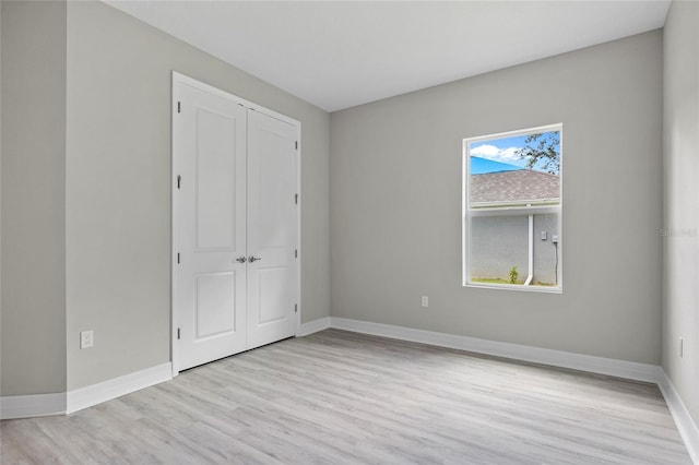 2404 Hanford Ln, North Port, FL 34288 - unfurnished bedroom featuring baseboards, wood finished floors, and a closet