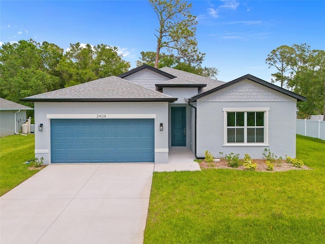 2404 Hanford Ln, North Port, FL 34288 - ranch-style house featuring a garage, stucco siding, concrete driveway, and a front lawn