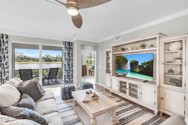 living room featuring crown molding, light tile patterned floors, a water view, and ceiling fan