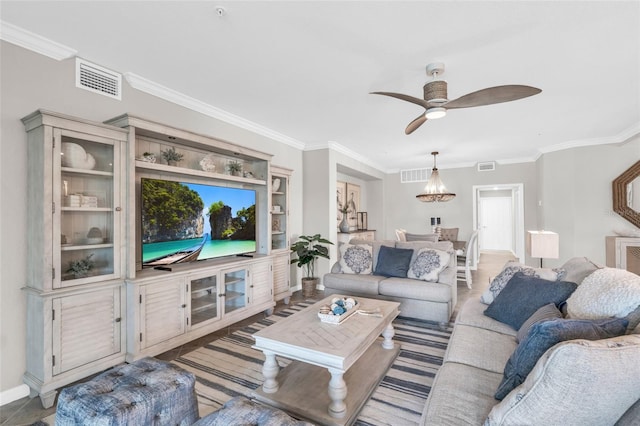 living room with crown molding and ceiling fan