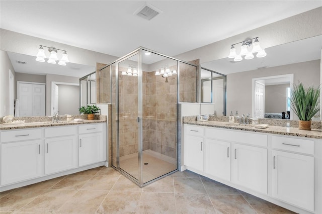 bathroom with vanity, walk in shower, and tile patterned flooring