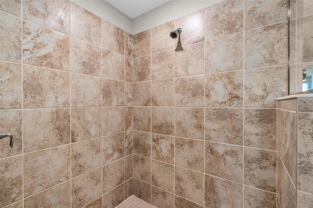 bathroom with tiled shower