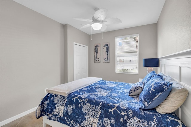 tiled bedroom with a closet and ceiling fan