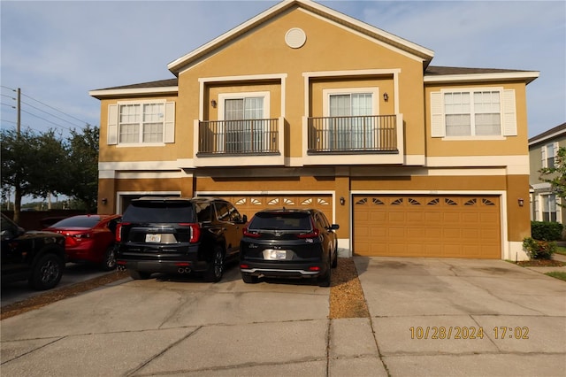 townhome / multi-family property featuring a garage and a balcony