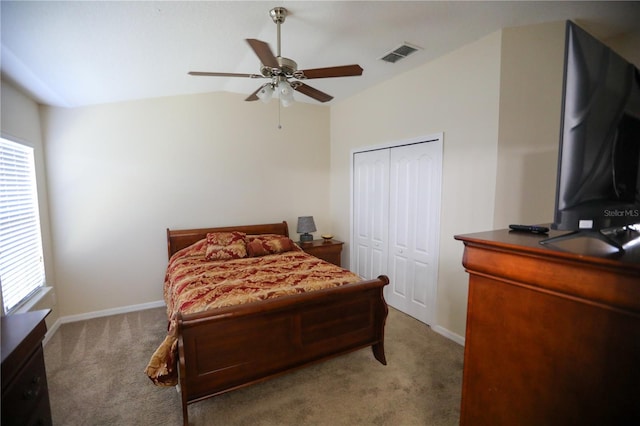 carpeted bedroom featuring ceiling fan, a closet, and vaulted ceiling